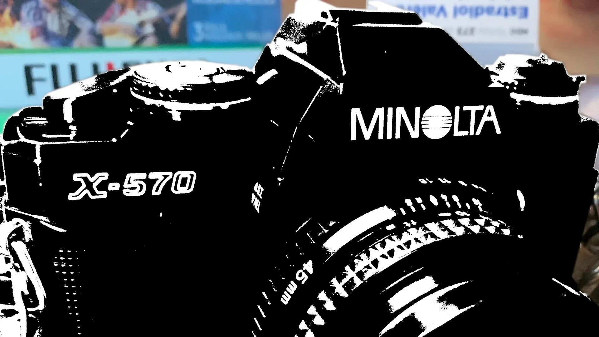 A distorted image of a Minolta X-570 film SLR camera.